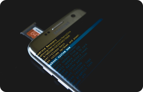 Sim card tray ejected from a Samsung Galaxy Android phone while the screen displays the boot menu