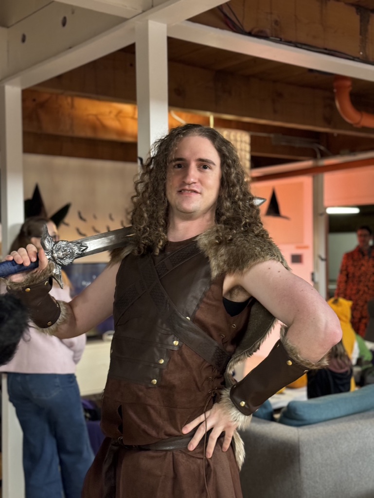 Merlin dressed in a barbarian costume for the annual PLUS QA Halloween party