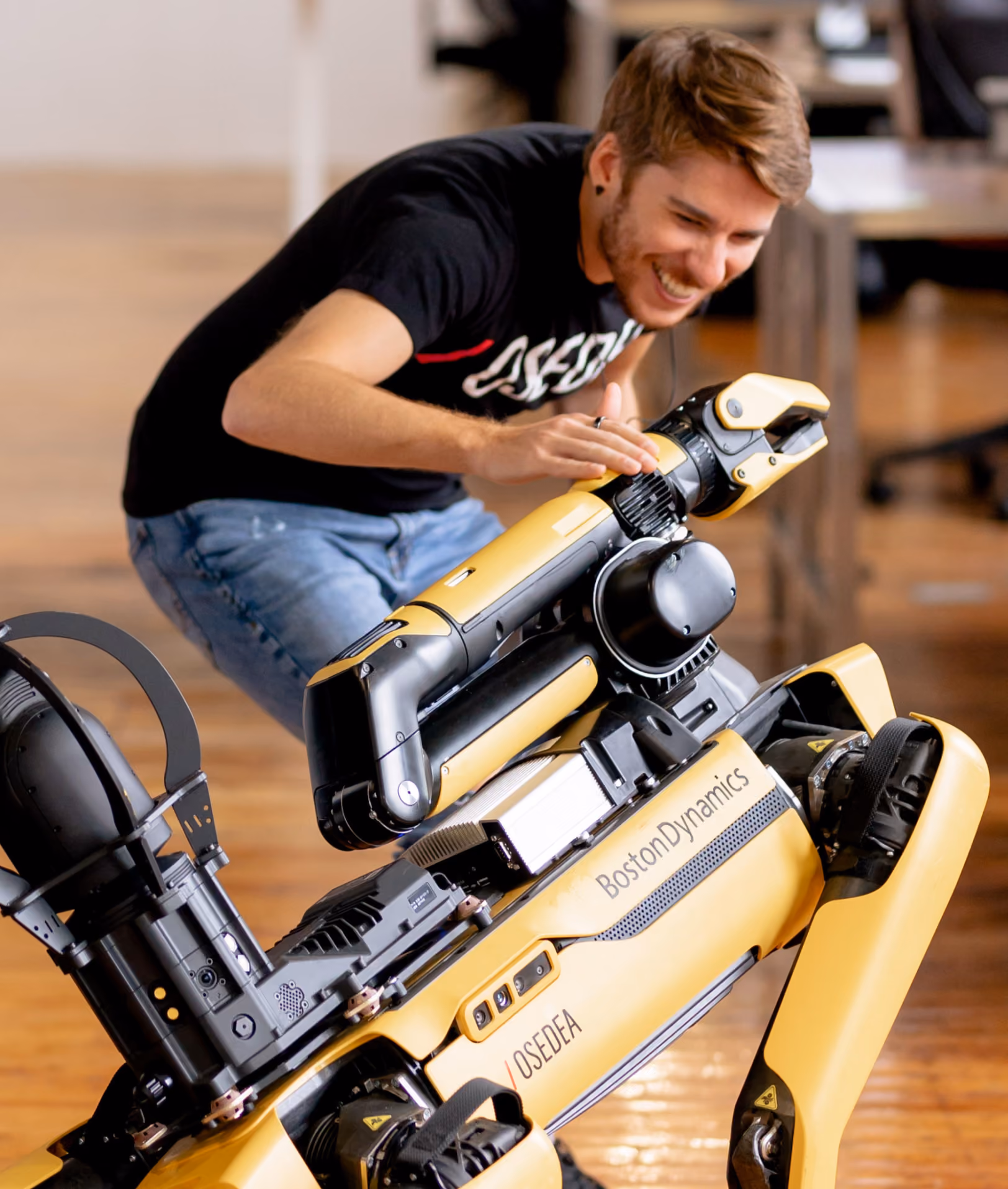 An Osedea employee next to a robot made by Boston Robotics