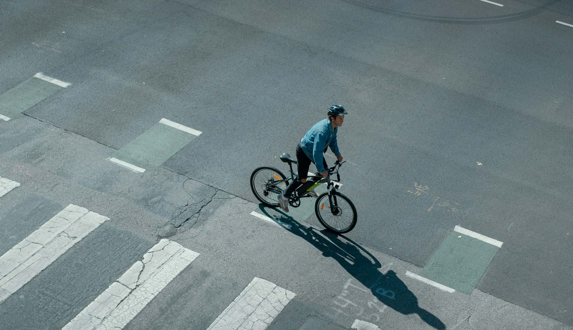 Arial view of a man bicycling in the city.