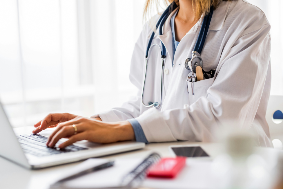 Female doctor working at her computer.