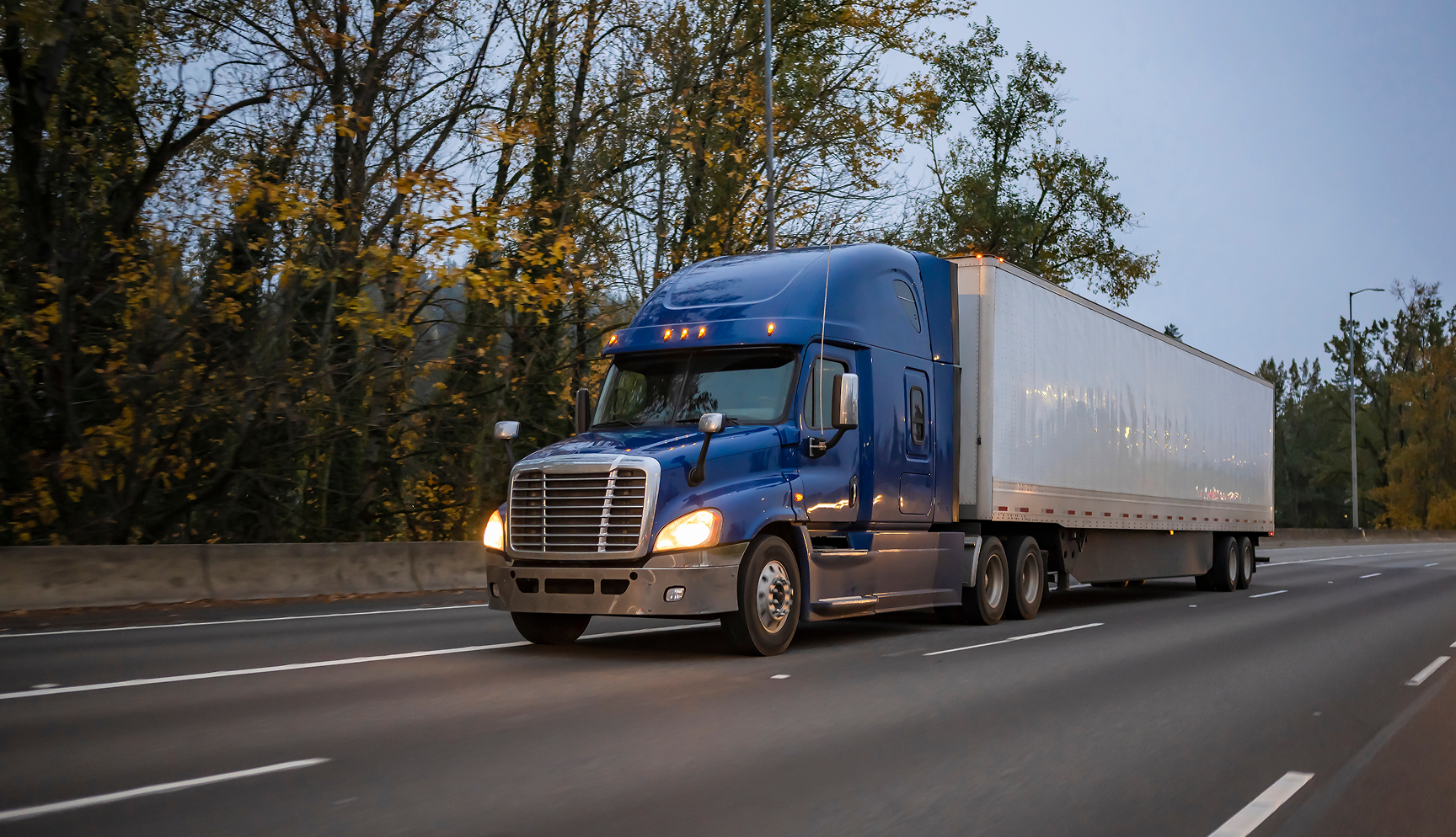 Big blue truck on the highway.