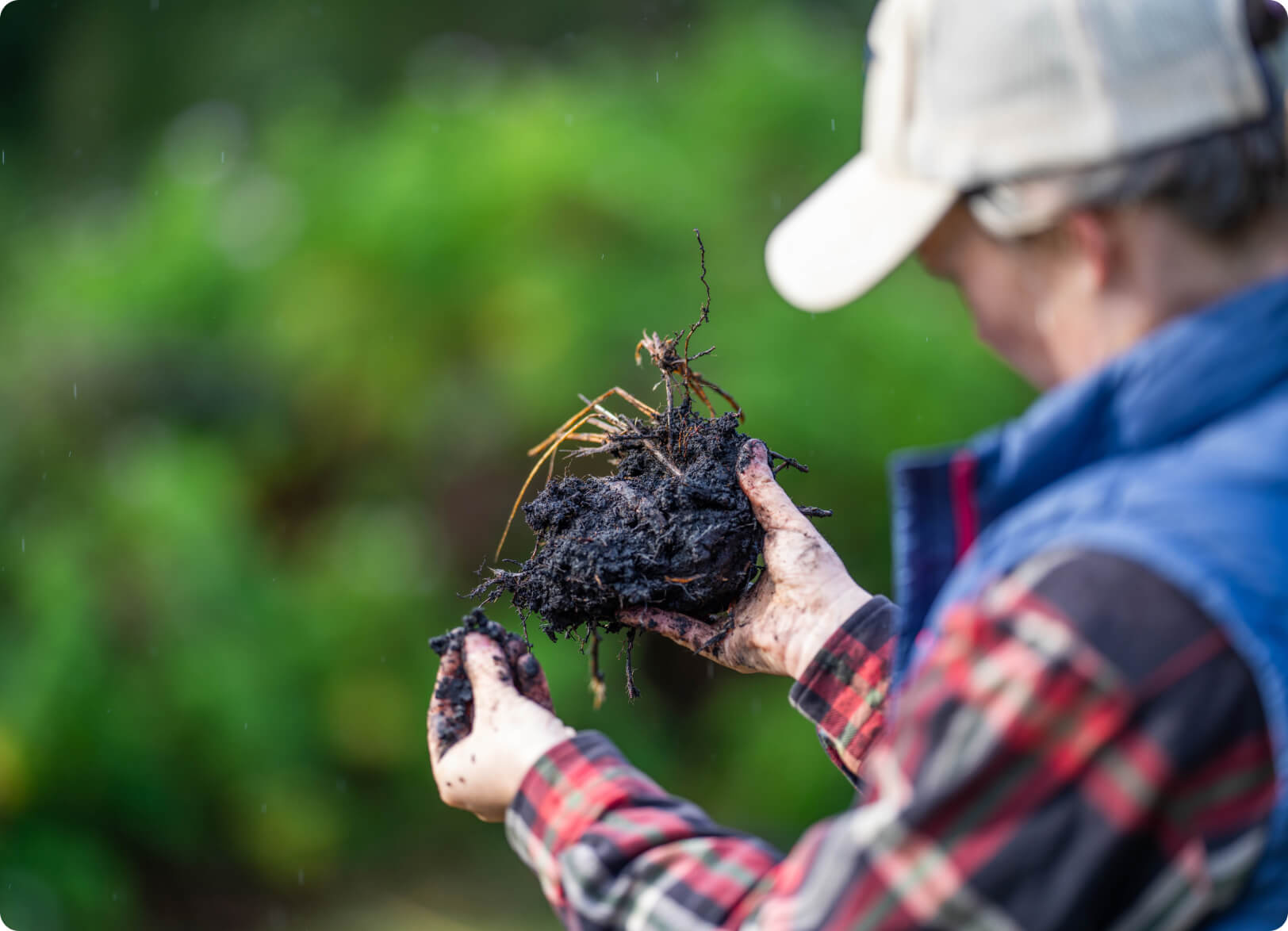 Photo of a farmer analyzing soil