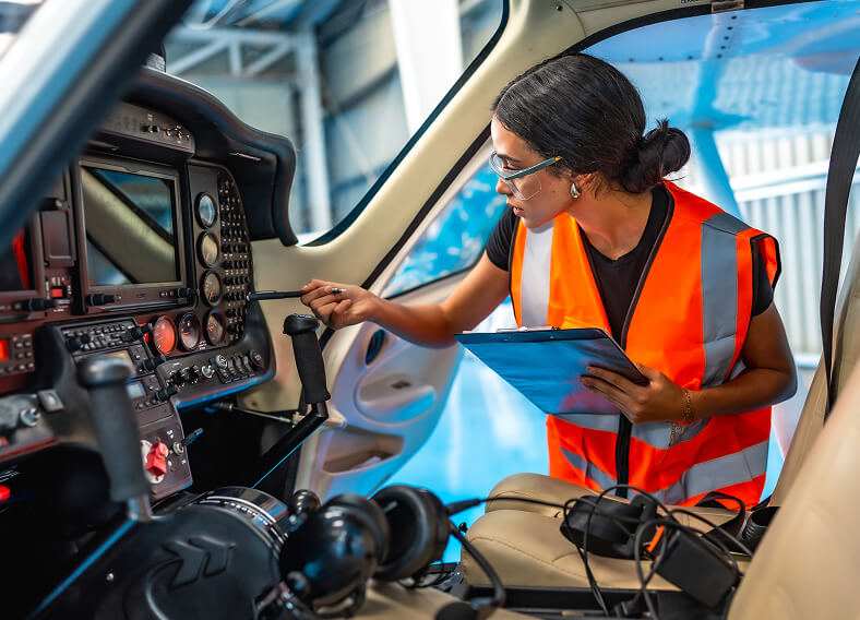 A person doing the aircraft maintenance in the cockpit of a plane.