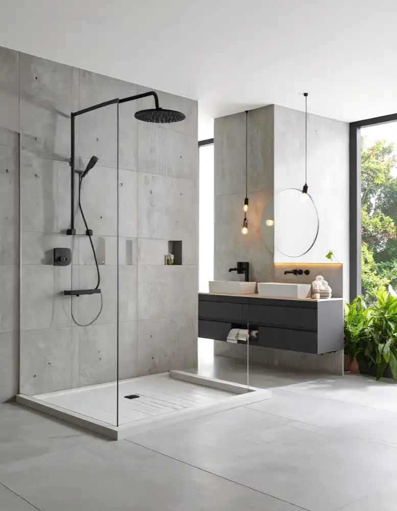 Modern bathroom with walk-in shower, black fixtures, floating double sink vanity, and large window with plants.