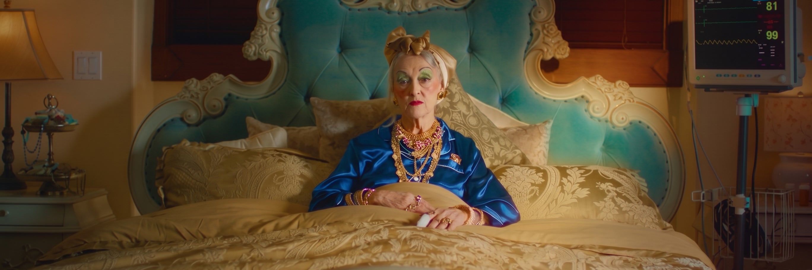 Still of Great Aunt Bertha in bed from the Unvault Family Jewels commercial.