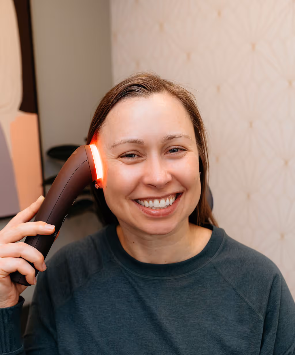 Beautician doing led light therapy to woman in SPA salon, facial phototherapy for skin pore cleaning