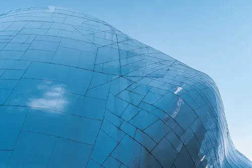 Exterior of the MOPOP building, blue detail against a blue sky