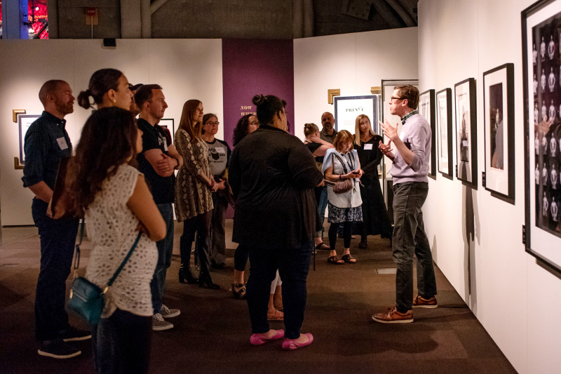 A museum tour in a MOPOP exhibition with a group of adults listening