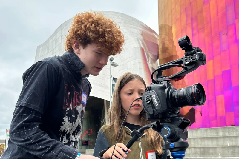 Two kids filming outside of MOPOP