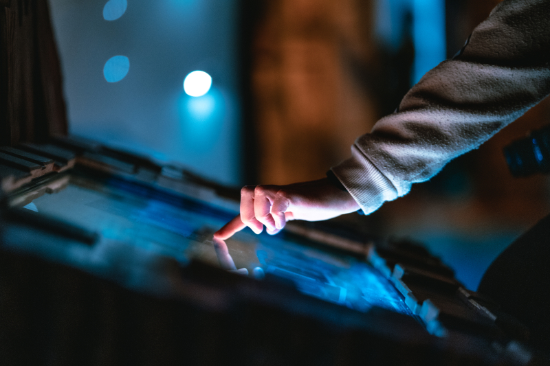 Close up of a hand interacting with a touch screen in the Fantasy exhibition