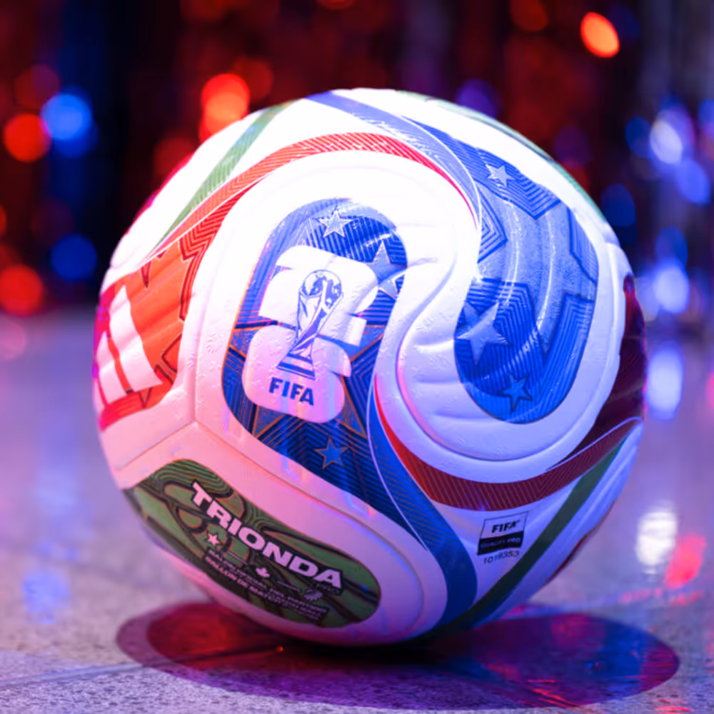 Colorful FIFA Trionda soccer ball with red, blue, and green patterns on a reflective surface.