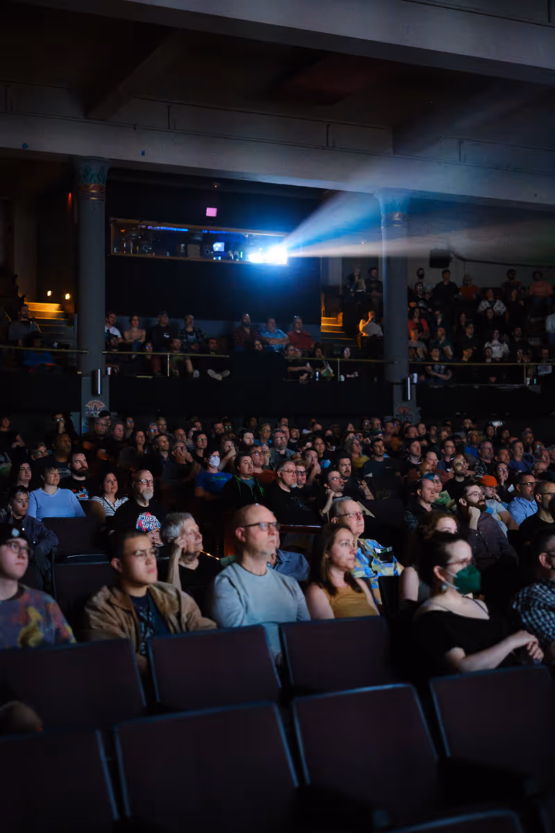 A group of people in a theatre watching the screen