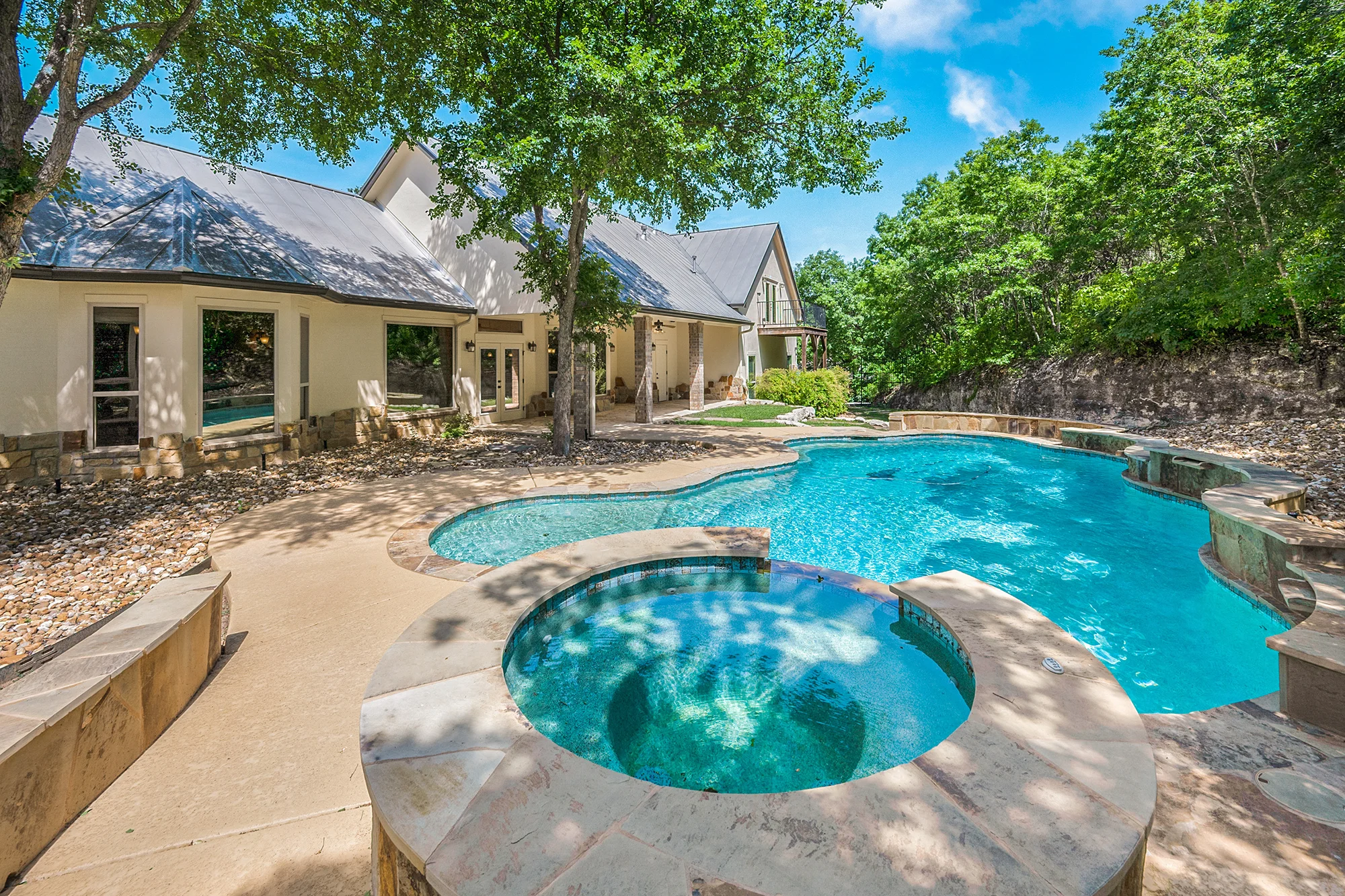 An outdoor covered patio with grills and refrigerators