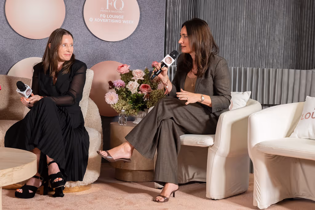 Two women speak during a live panel at FQ Lounge, part of Advertising Week, engaging in a discussion.