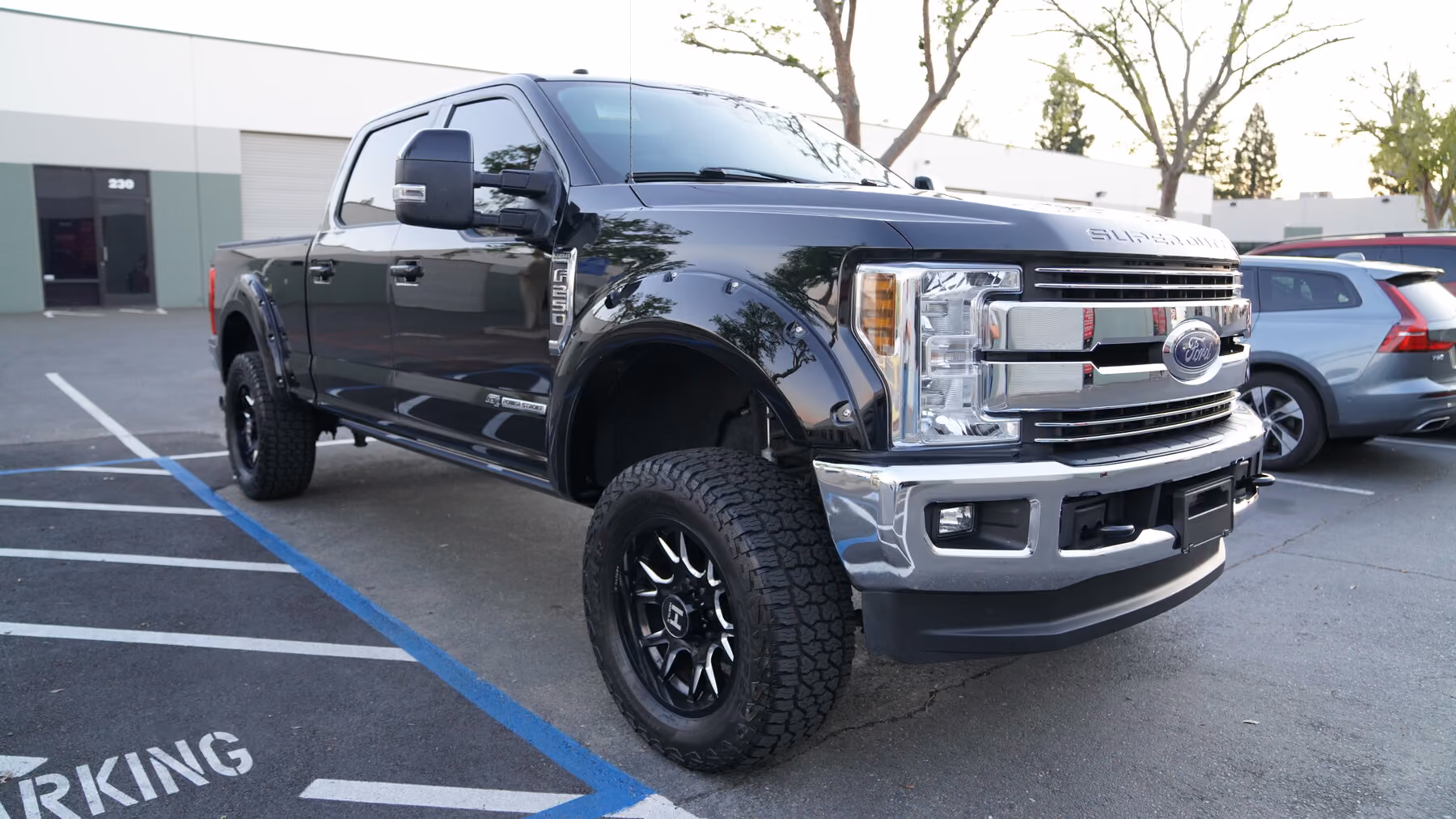 Glossy black Ford F-250 Super Duty with a ceramic coating finish at BGI Pro Auto Detailing in Sacramento