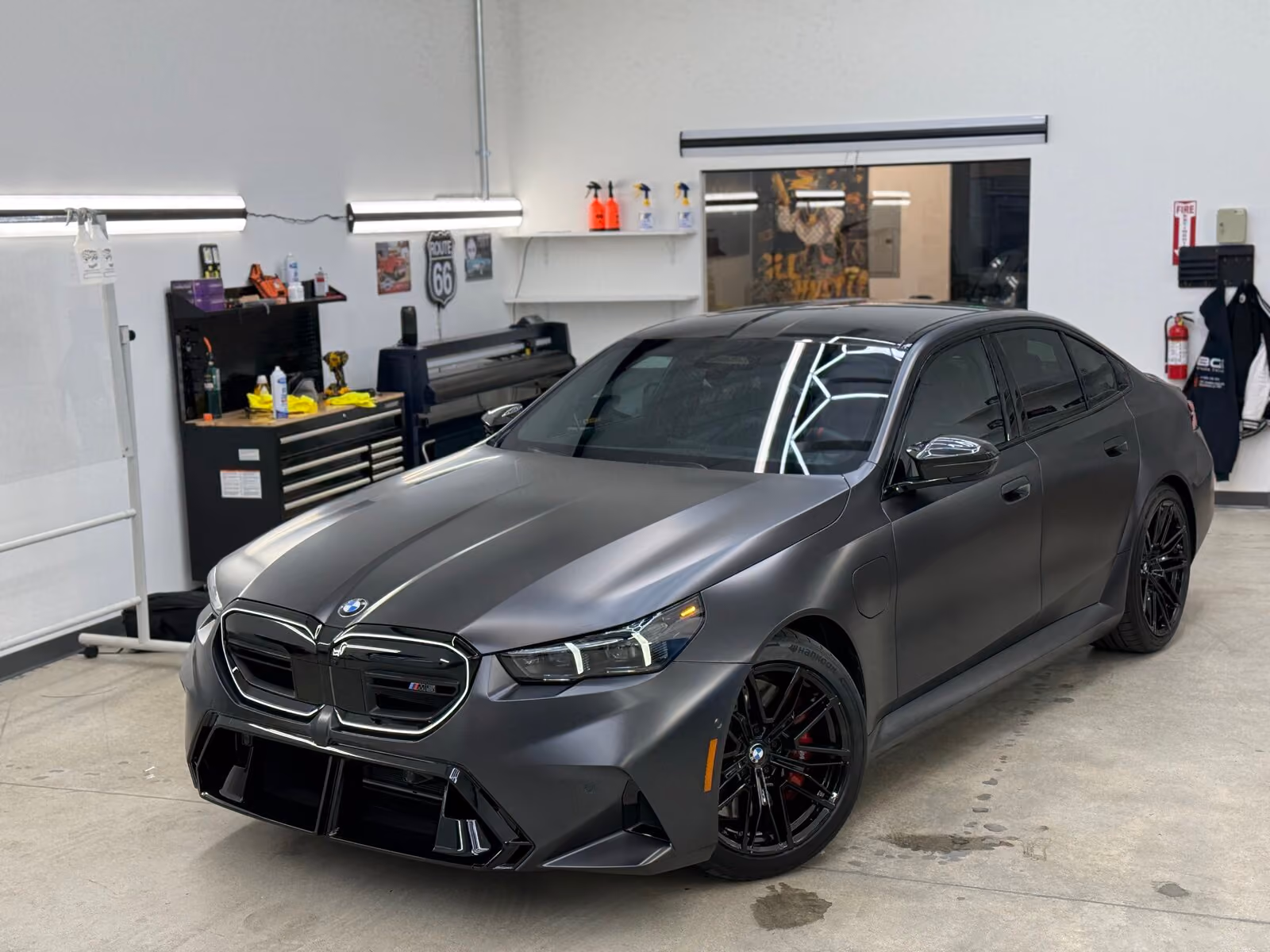 Matte black BMW i5 with dark window tint at BGI Pro Auto Detailing in Sacramento