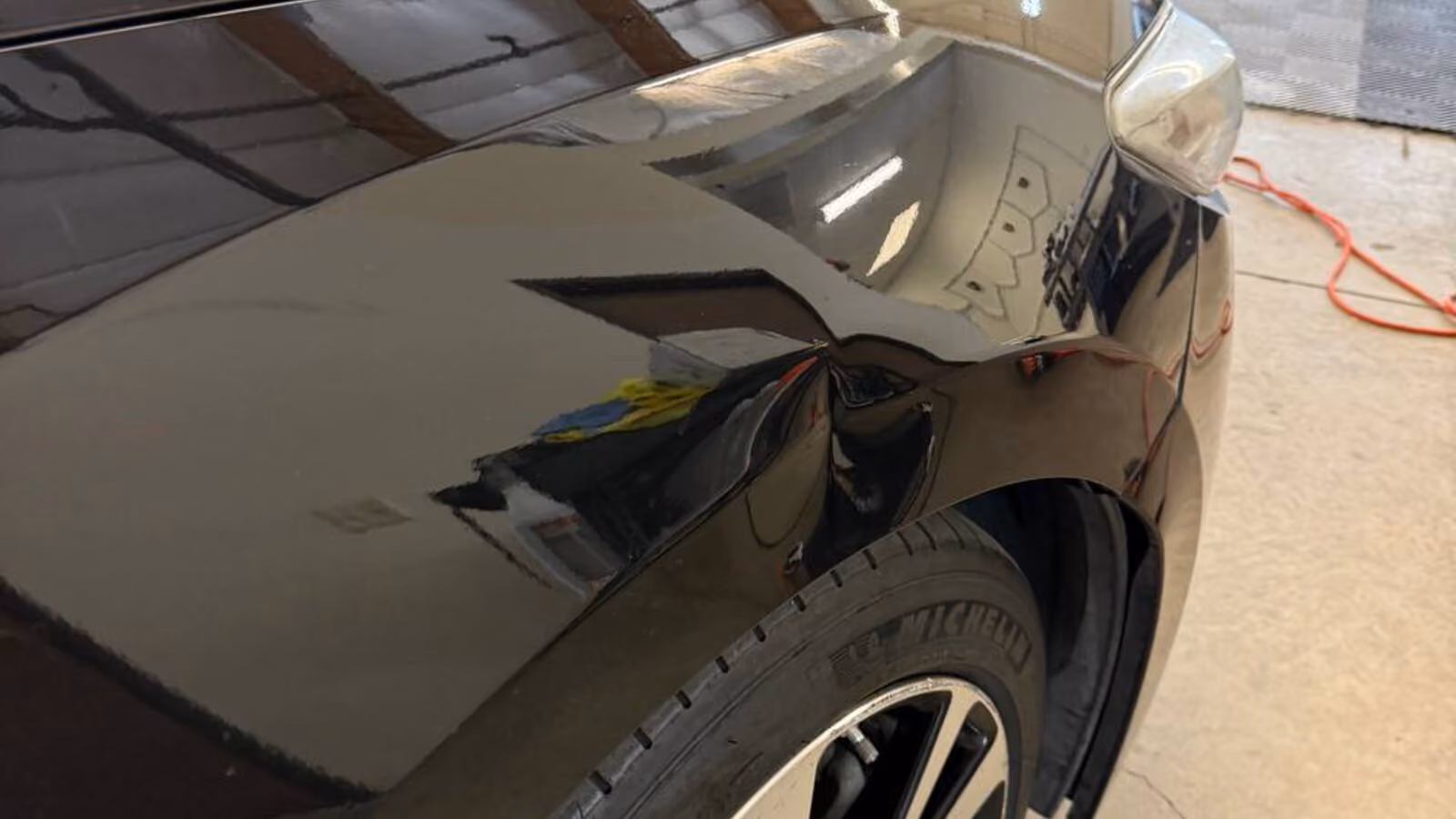 BMW vehicle inside Bugai Pro Auto Detailing workshop with open door during detailing service