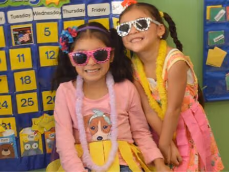 two girls with glasses smiling