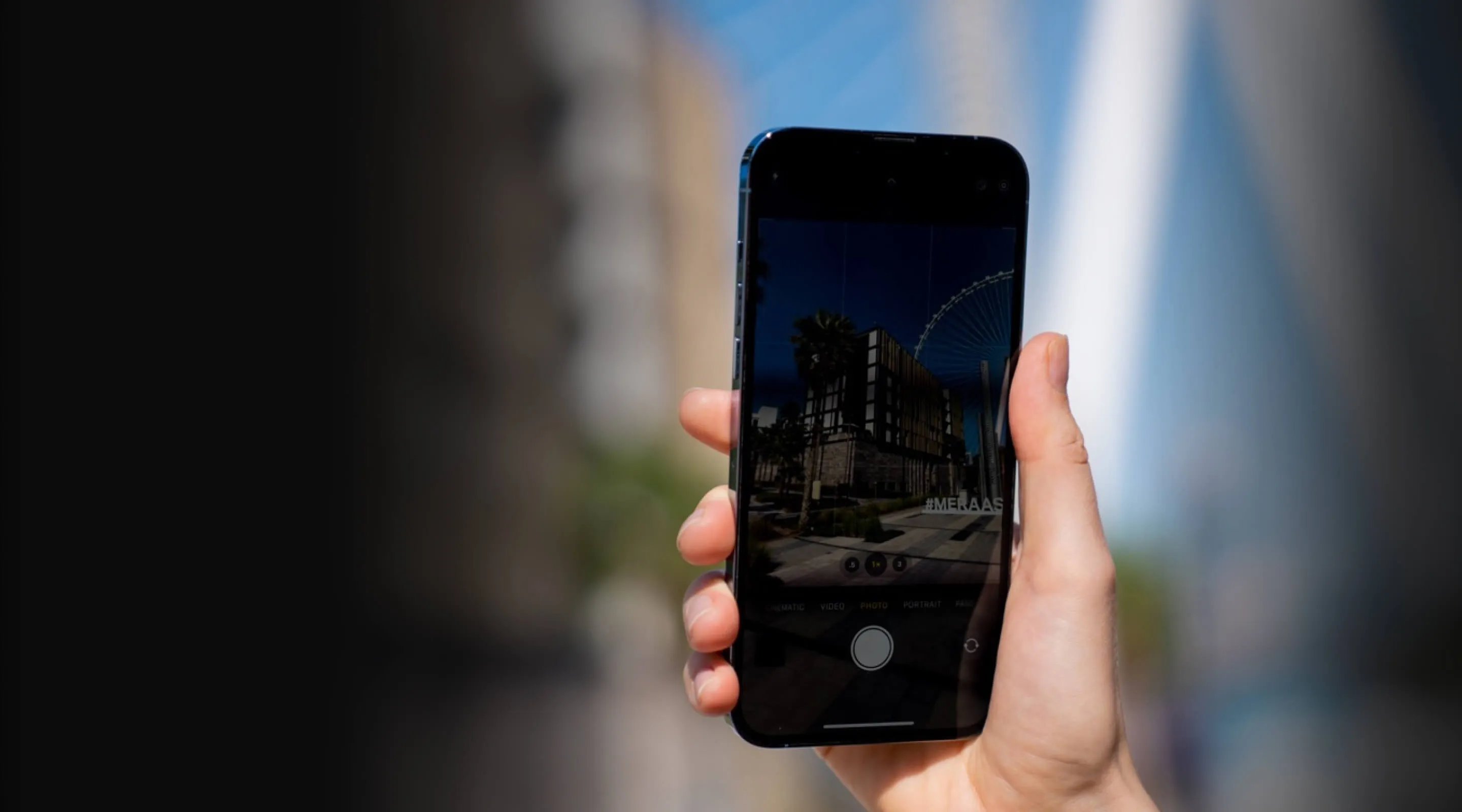 Hand holding iPhone, displaying camera view