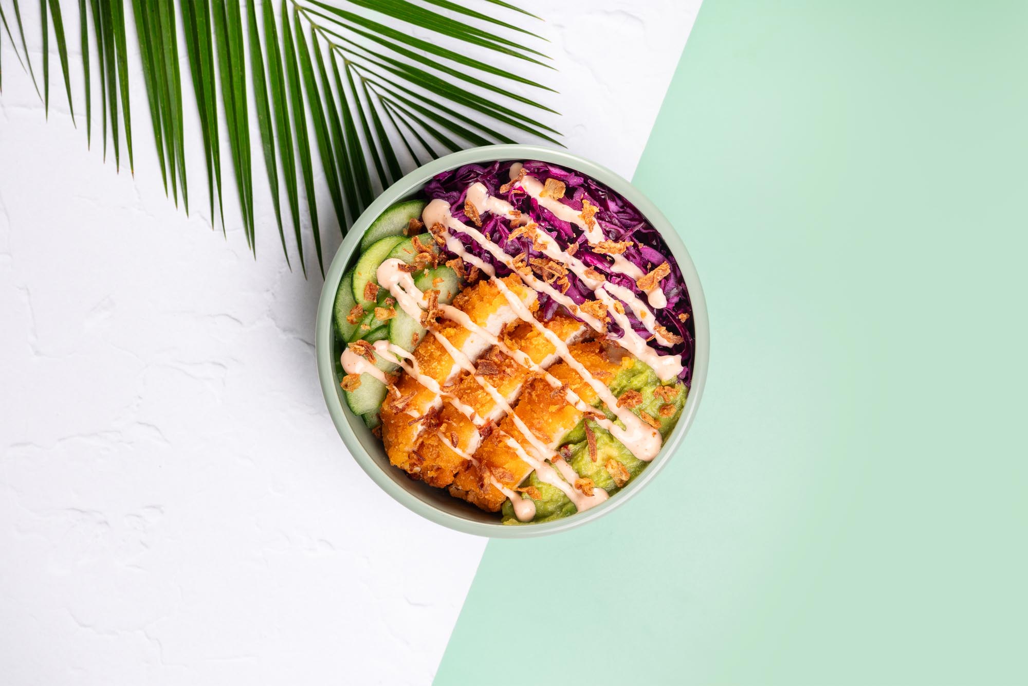Low-angle view of a street at night with a close-up of a car wheel and neon-lit signs in Japanese on buildings.