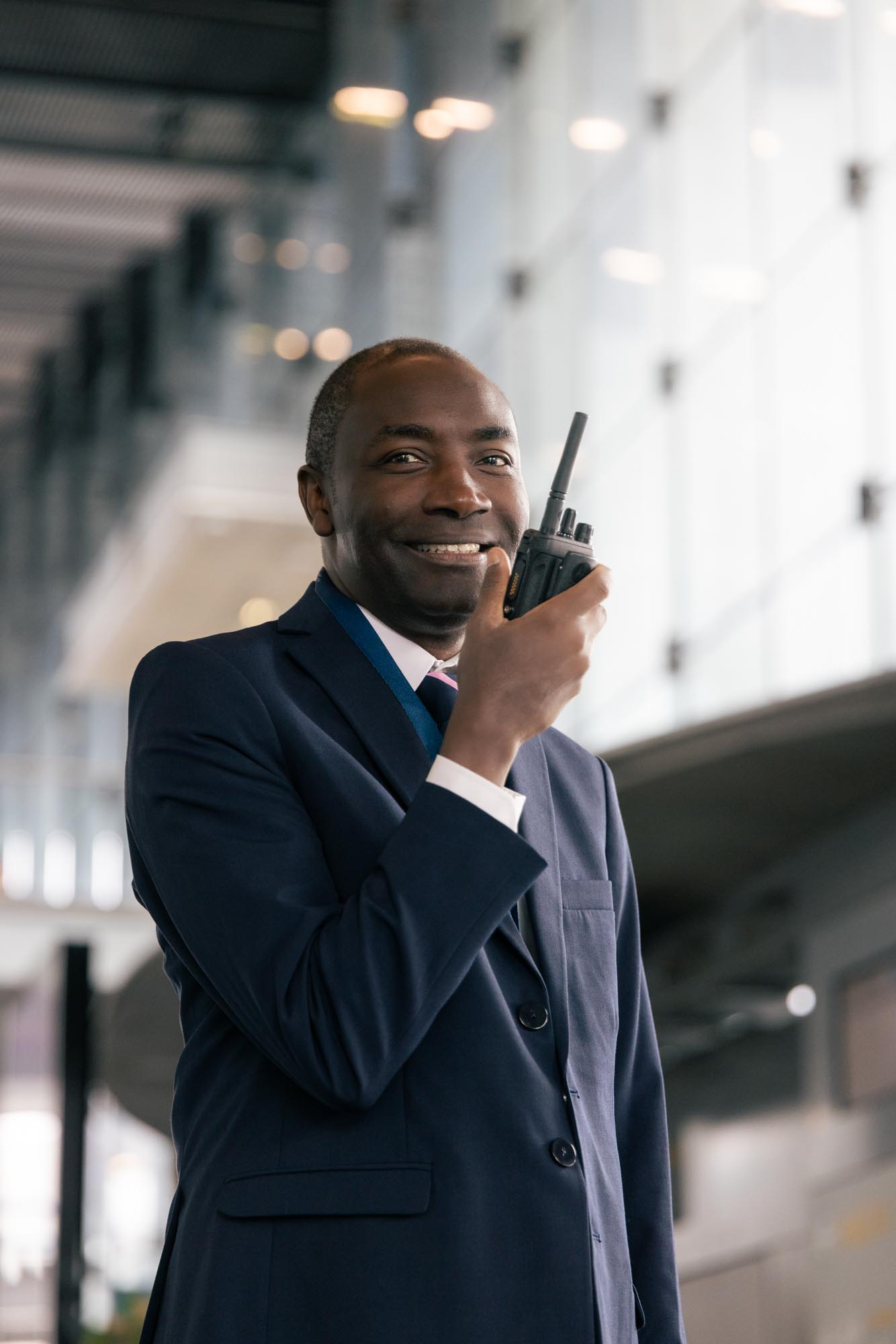 Low-angle view of a street at night with a close-up of a car wheel and neon-lit signs in Japanese on buildings.
