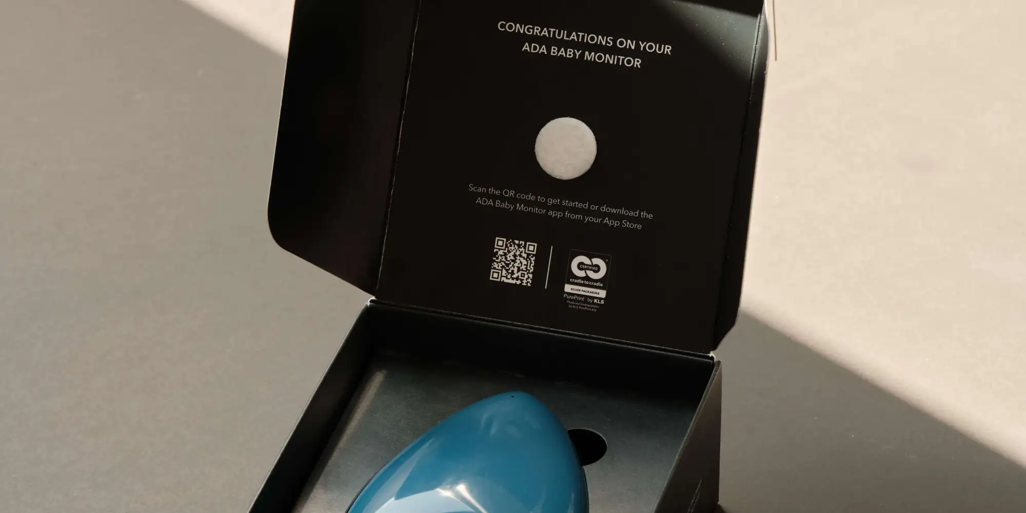 Blue ADA Baby Monitor on a bedside table