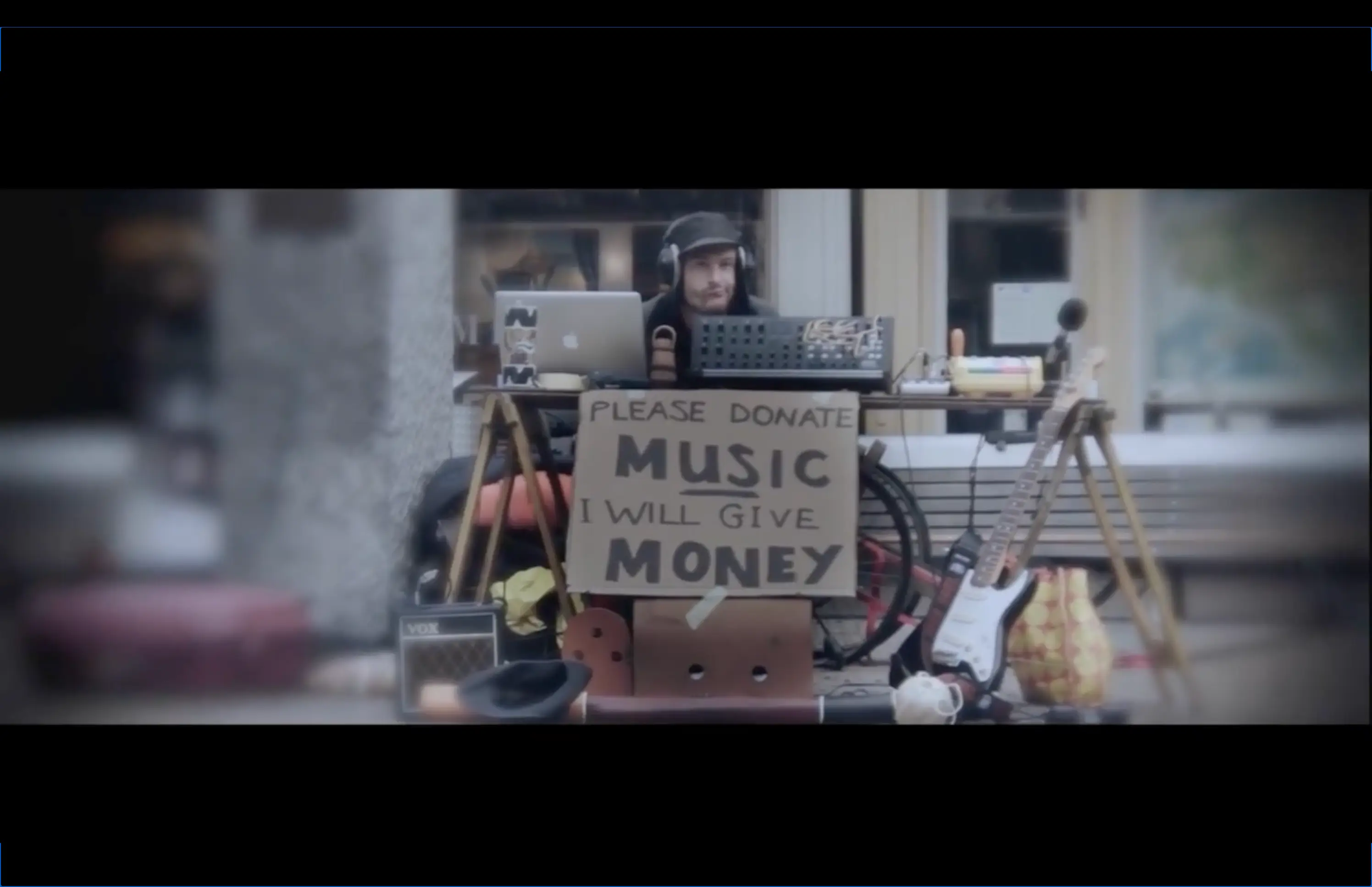 View over 't IJ waterfront in Amsterdam at dawn, with misty waters