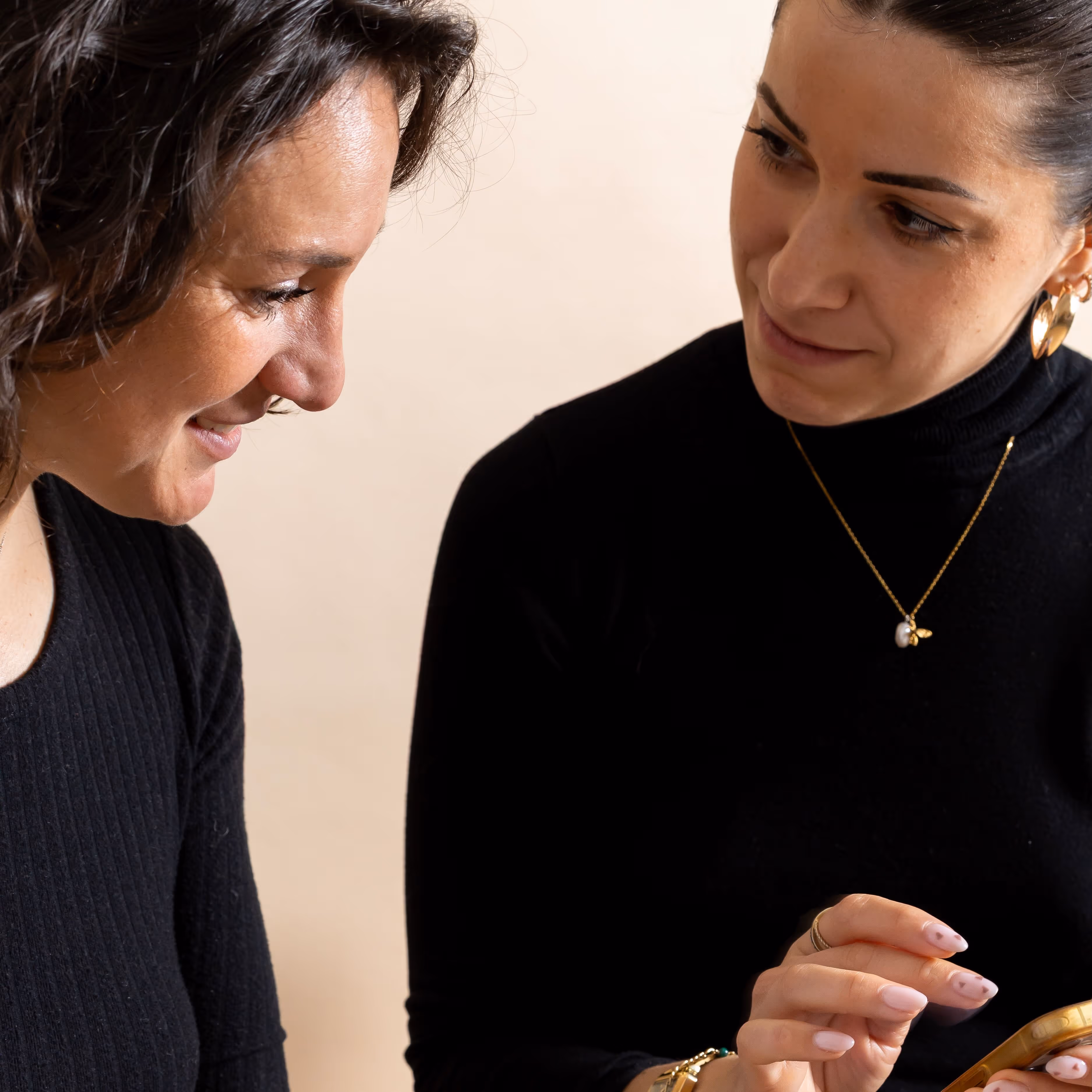 A portrait of both Lola, founder, and Victoria, marketing manager, working on a laptop