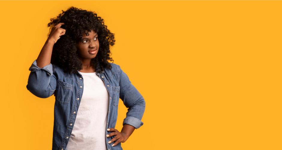 Woman scratching her head with a confused look on her face in front of a yellow background, wondering "What is a privacy policy?"