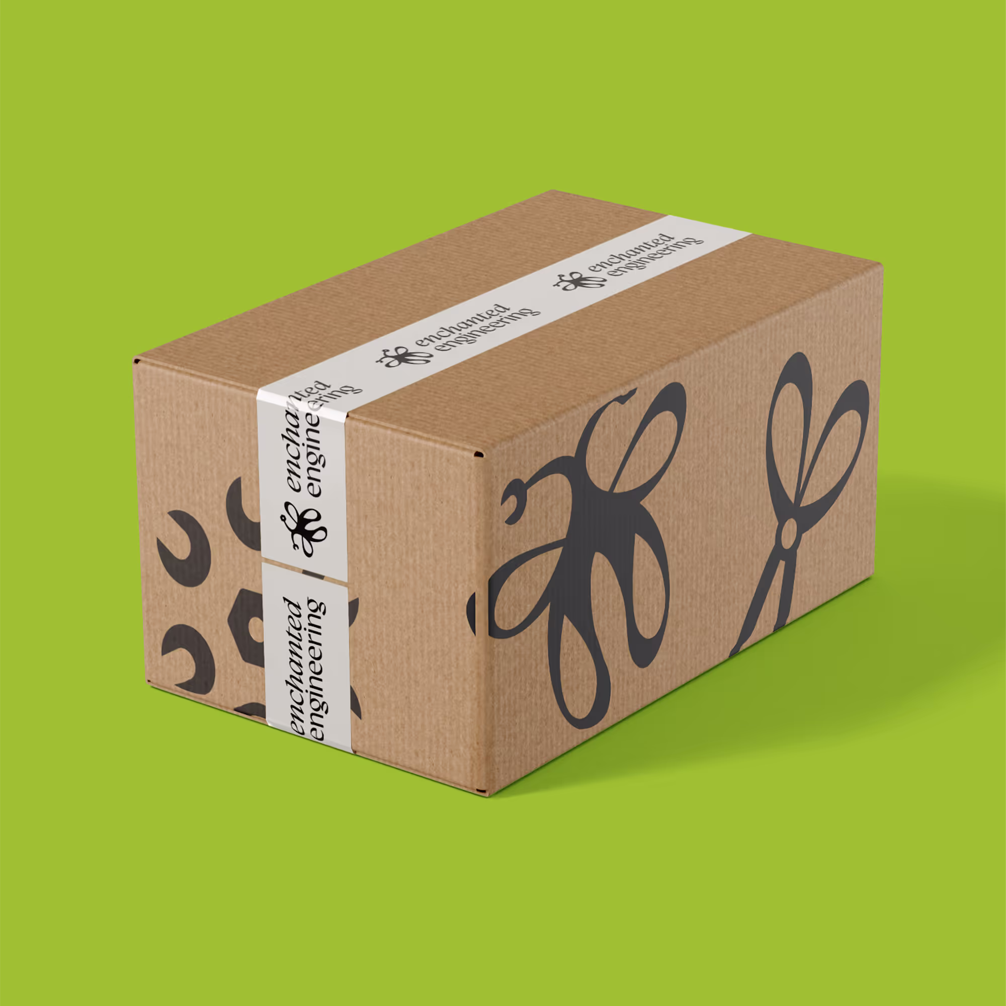 Enchanted Engineering branded cardboard box, with branded white tape. It's on a yellow-green background.