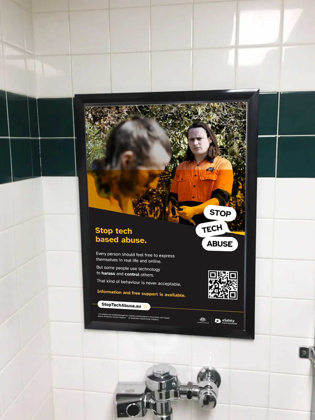 Stop Tech Abuse poster displayed above a urinal