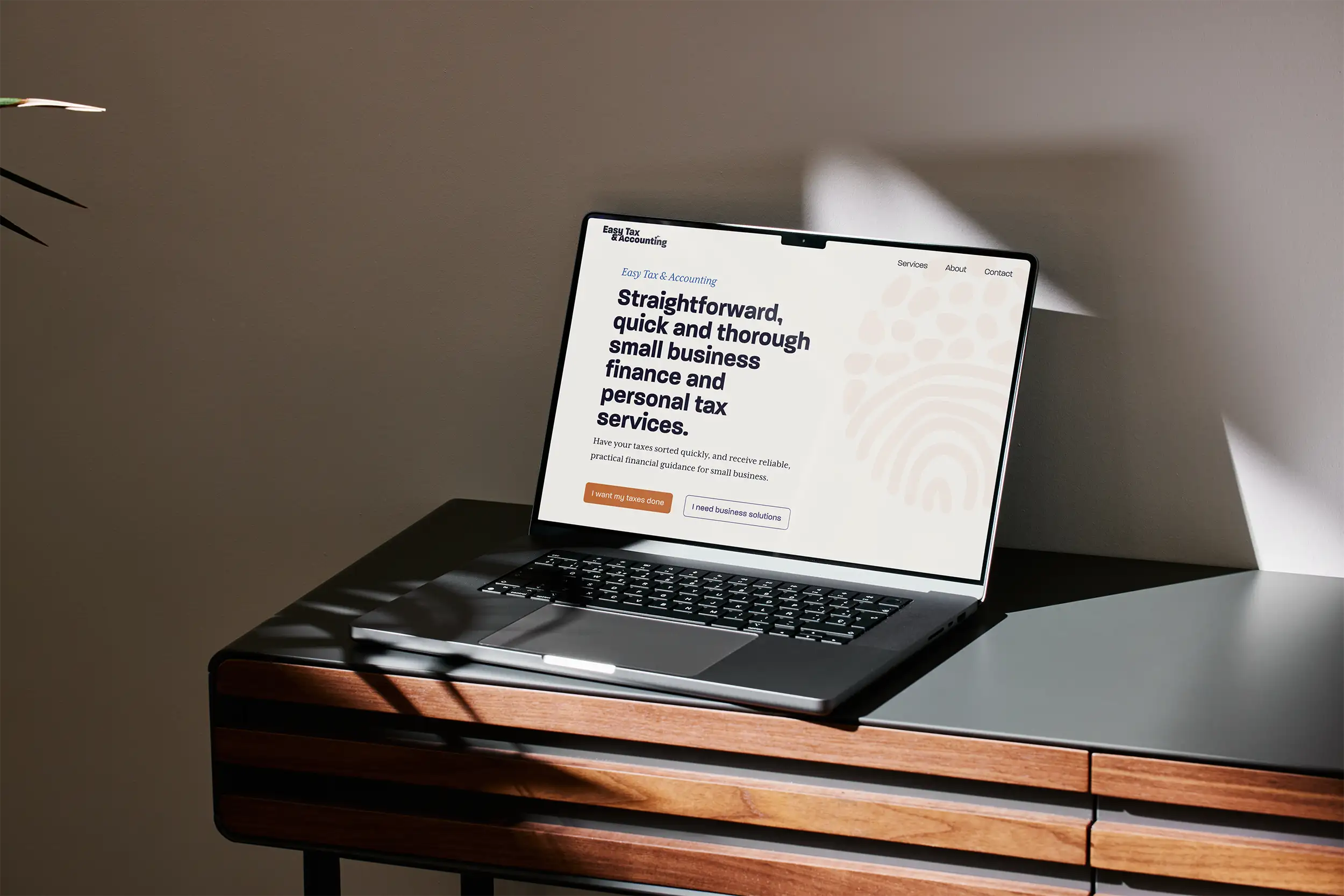 Laptop with Easy Tax home page, sitting on a desk