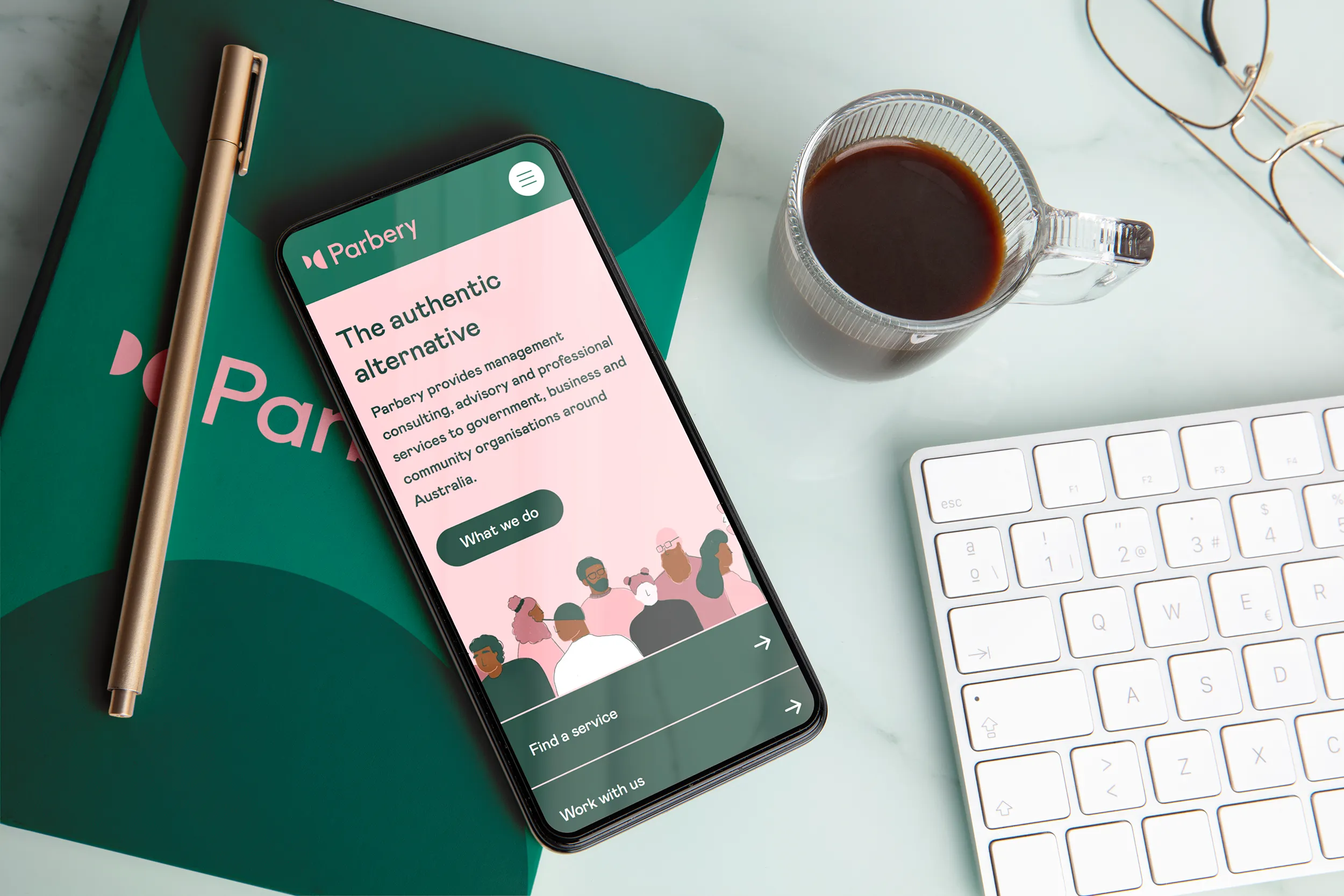 Mockup of Parbery home page on a phone. The phone is sitting on top of a Parbery branded notebook.