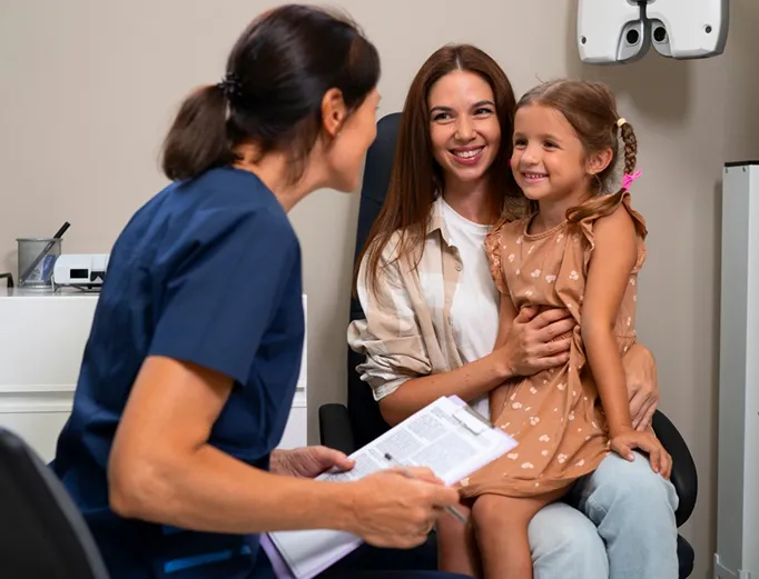 Nurse greeting a mother and her child