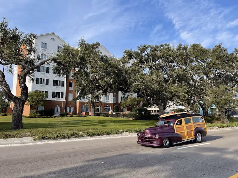 Woodie with surfboard on top "cruisin the coast"