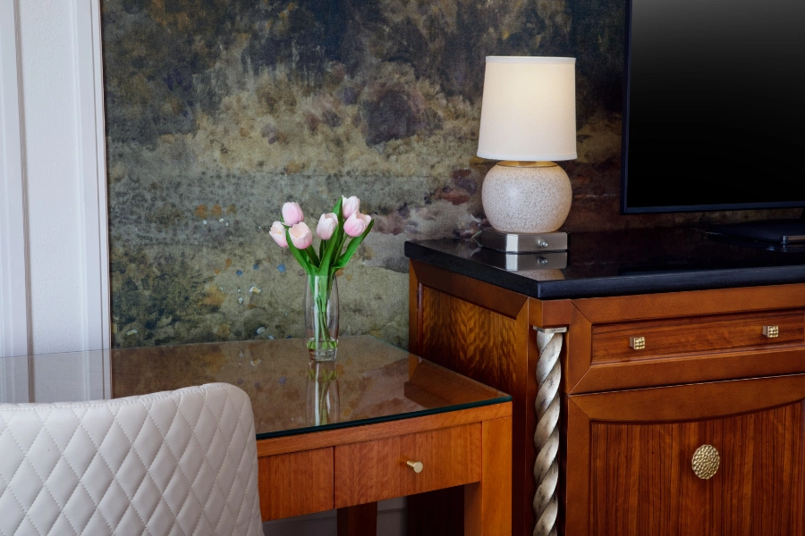 Table Desk in room with flowers and lamp