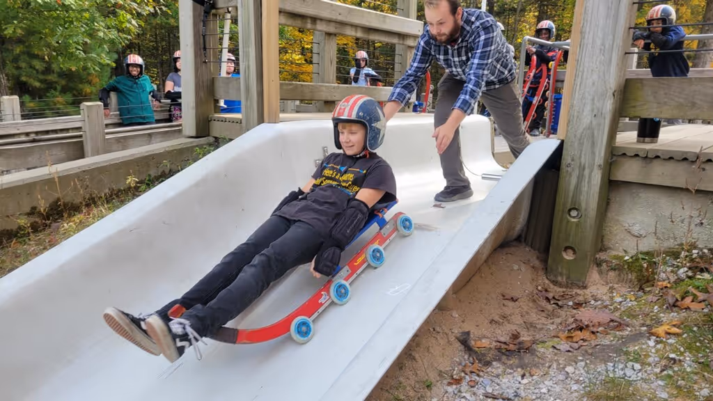 Student riding the Muskegon Luge.