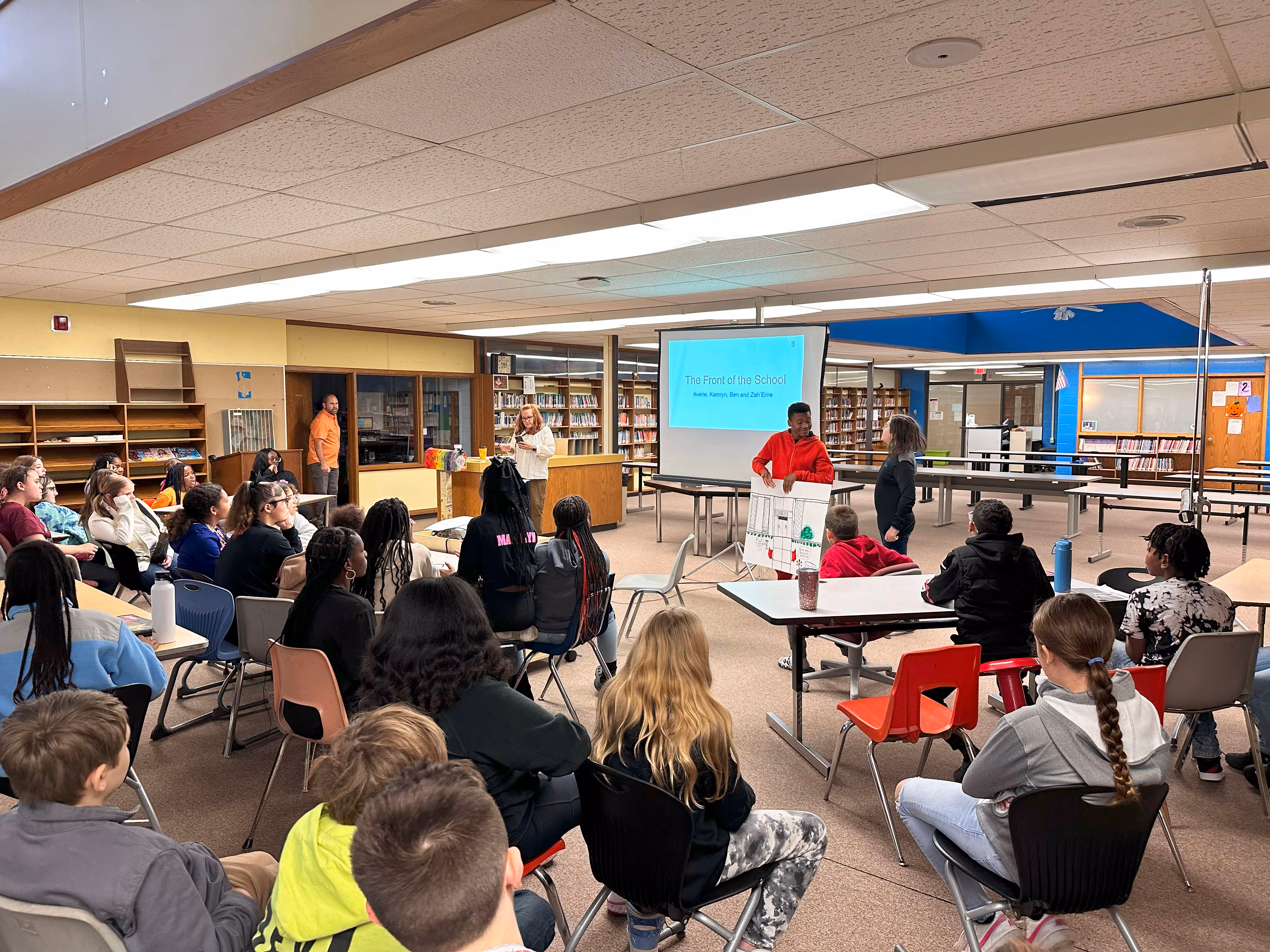 Students presenting to the student body on ways to improve their school.