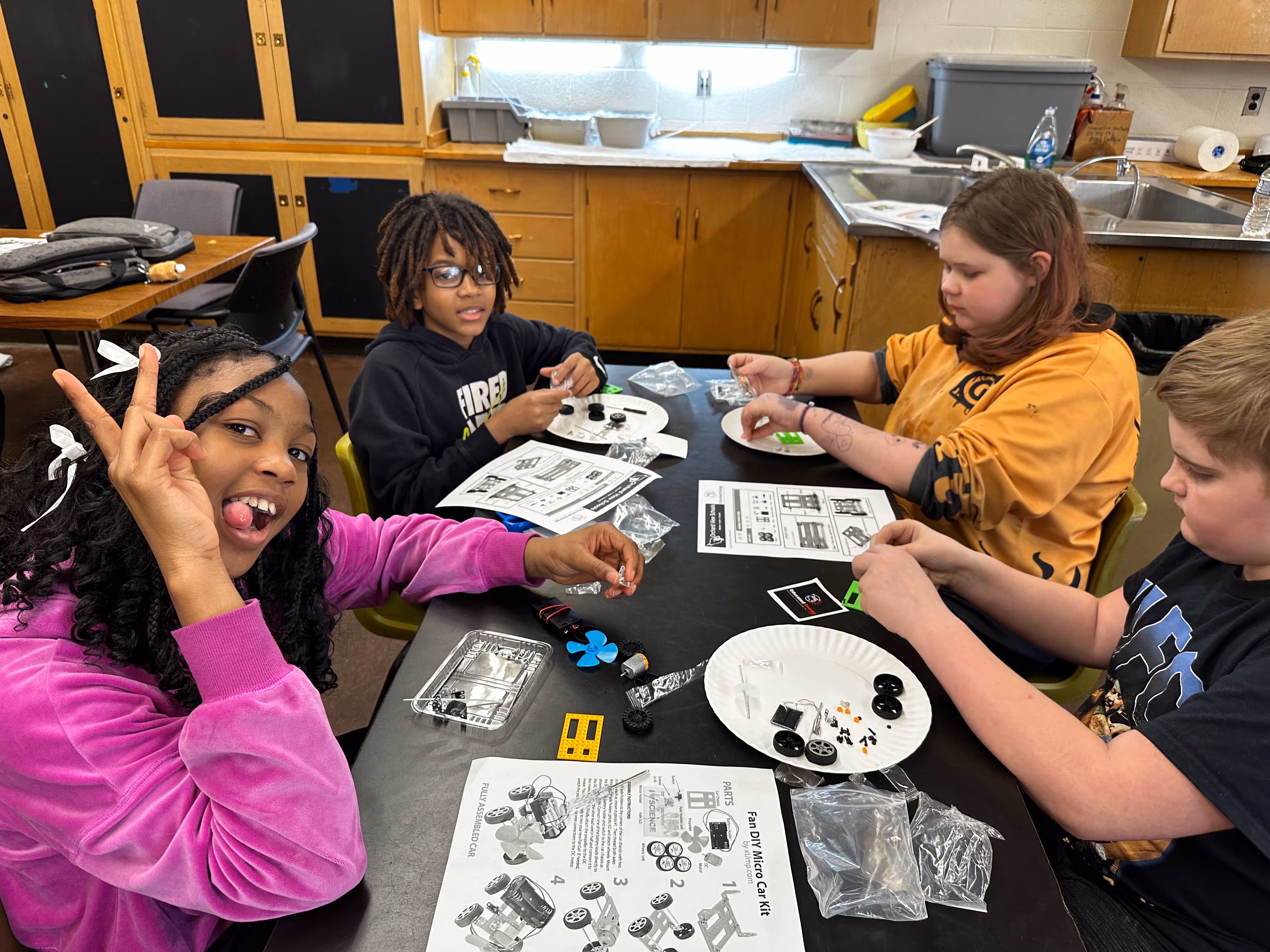 Student posing near collaborative engineering work.