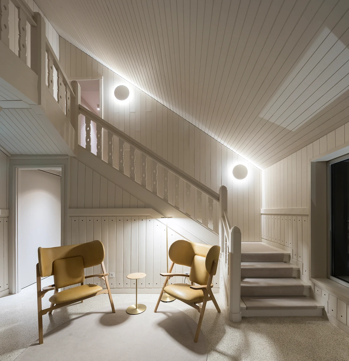 Minimalistische Holztreppe und stilvolle Design-Sessel im stilvollen Interieur des Hotels Casa de São Lourenço.
