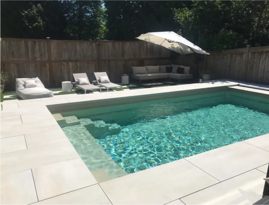 Fiberglass pool installed in the the backyard of a house by Aria pool contractors
