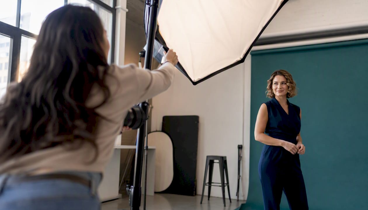 Photographer adjusting lighting for founder headshot