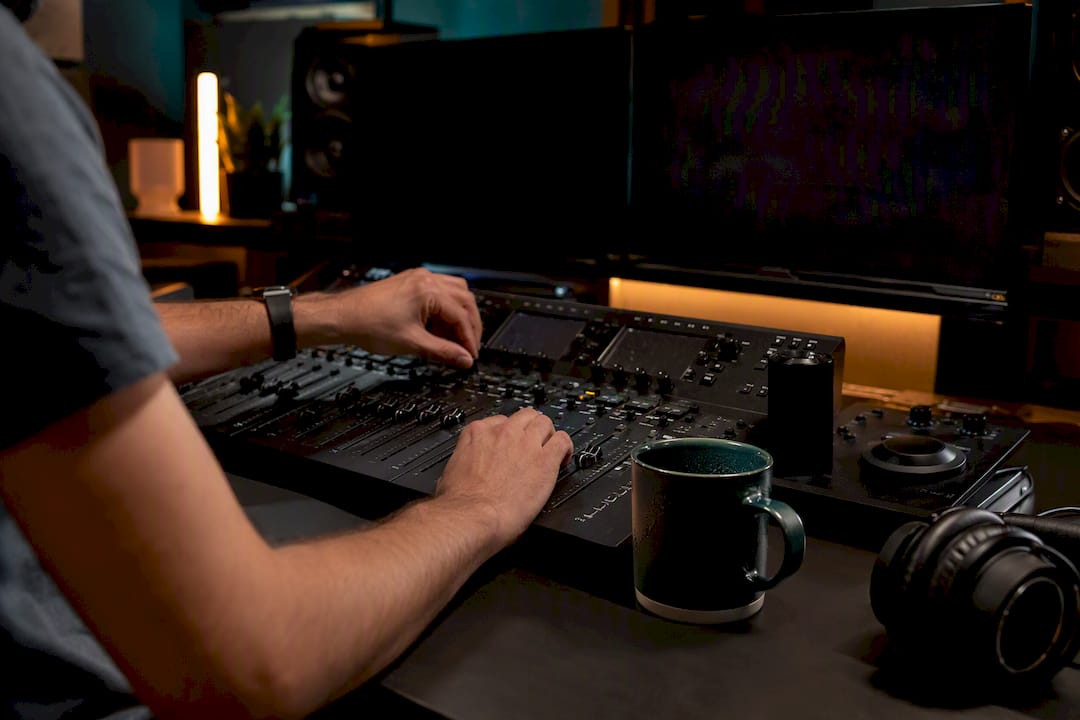 Hands editing video on dual tracks in studio