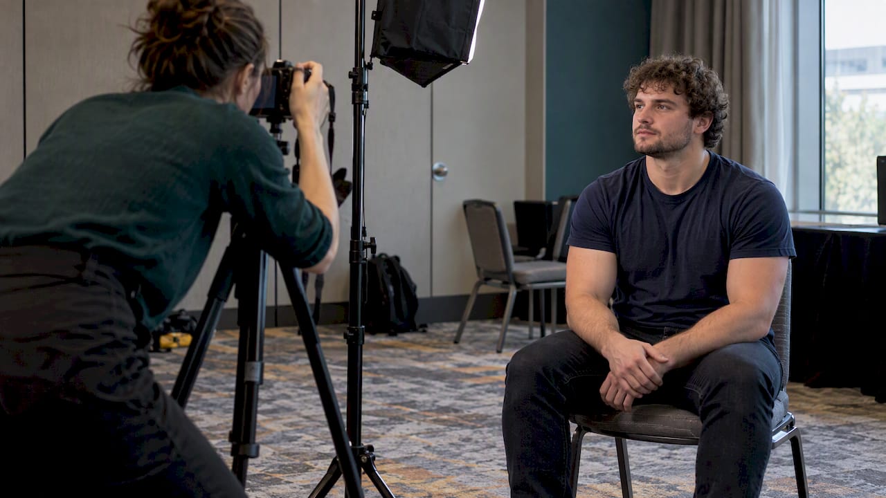 Photographer testing headshot lighting in venue