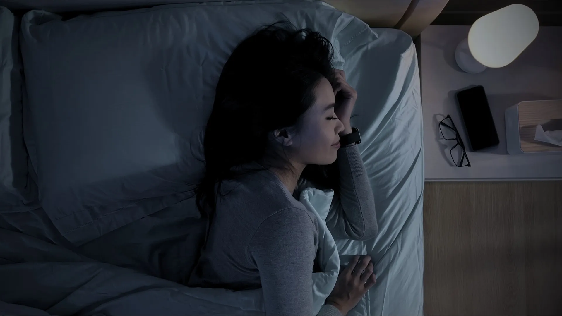 A woman sleeping with a smart watch