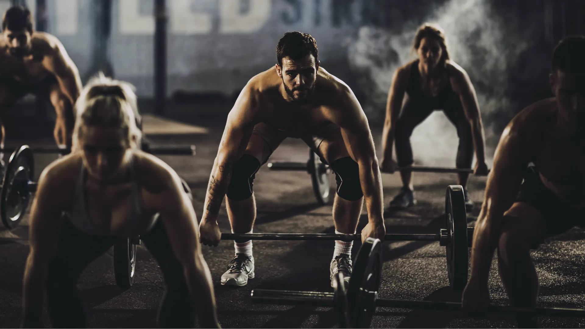 People lifting weights in a gym class