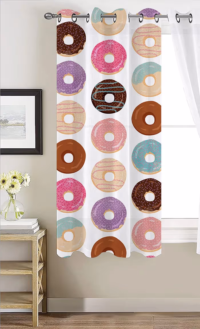 Doughnuts of various colors in vertical lines on a white curtain secured in front of a window