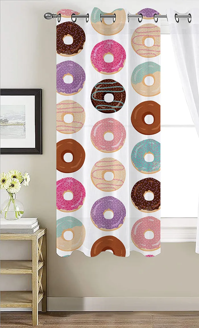 Doughnuts of various colors in vertical lines on a white curtain secured in front of a window