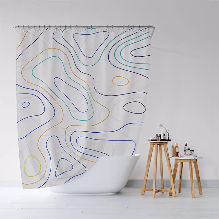 white shower curtain with blue, green, and yellow lines forming loose shapes in a loose pattern, there's a two wooden tables next to the bathtub 